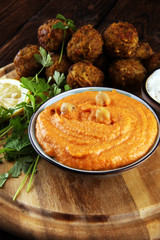 Traditional homemade hummus, falafel and chickpea served with spices on table. Jewish Cuisine.