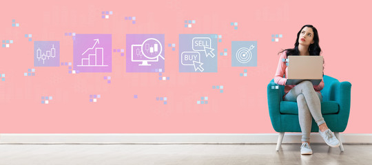 Stock trading concept with young woman using a laptop computer