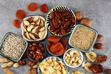 dried fruits and assorted nuts composition on rustic table
