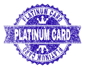 PLATINUM CARD rosette seal watermark with distress style. Designed with round rosette, ribbon and small crowns. Blue vector rubber print of PLATINUM CARD text with scratched style.