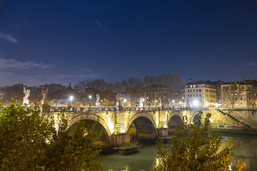 Fototapeta premium Night view of Bridge Called Ponte Sant'Angelo Crossing Tiber River Near Castle Saint Angelo and Vatican City.