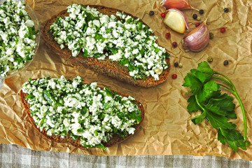 Obraz na płótnie Canvas Homemade open sandwiches with cottage cheese, garlic and greens. Healthy eating concept. Keto diet.