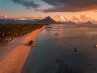 Aerial view of Flic and Flac beach in Mauritius, sunset light. Exotic beach sunset.