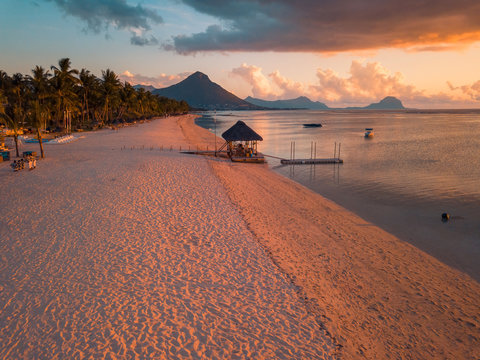 Aerial view of Flic and Flac beach in Mauritius, sunset light. Exotic beach sunset.