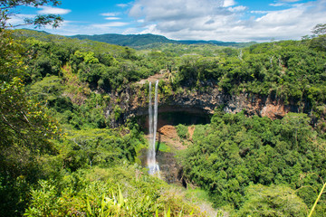 Fototapeta na wymiar Chamarel waterfall, Mauritius island. Beautiful view on green tropical forest with high waterfall.