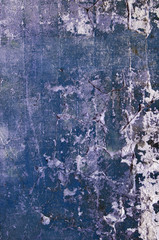 Background. Antique surface with cracks, potholes and stains of blue paint. Daylight shooting
