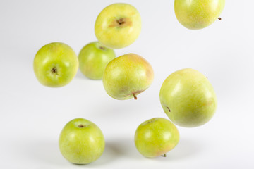 Falling ripe green apples