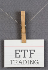 ETF trading written on an index card moored to a clothespin