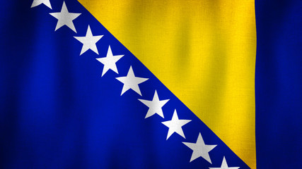 Bosnia and Herzegovina flag waving in the wind. Closeup of realistic Bosnian flag with highly detailed fabric texture