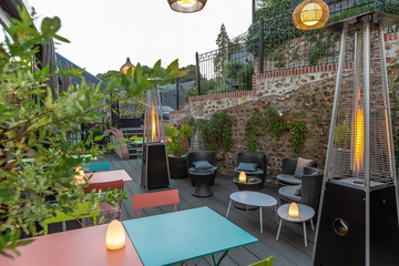 guest house, garden restaurant, color metal tables and outdoor lounge with floral decorations, gaz heating system,