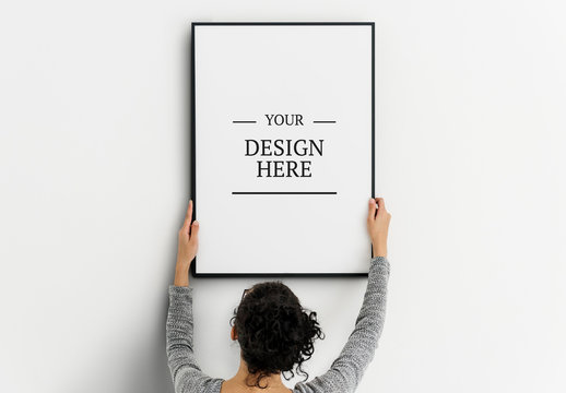 Person Hanging Frame on Wall Mockup