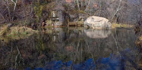 Tranquility Rock in Oak Creek. A large boulder sitting in a tranquil section of Oak Creek in Sedona Arizona.