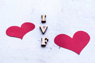 IVF (In Vitro Fertilization) acronym (abbreviation) and red hearts on light background.