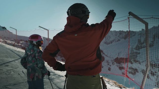 Male & child looking for the best route to take skiing in the Dolomites. Arraba ski resort, Italy