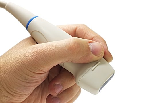 Adult phased array ultrasound probe used in cardiology and TCD examinations, held in left hand, white background