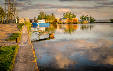 Fototapeta premium small harbour with a single boat at dawn or dusk. Narva reservoir on the Estonian, Russian border.