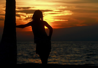 silhouette of young woman at sunset