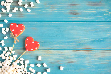 Background with two hearts and marshmallows on a wooden background. The basis for a banner on Valentine Day, Mother Day. Frame for a festive banner for designers