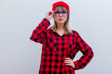 Young woman in red shirt and hat with glasses