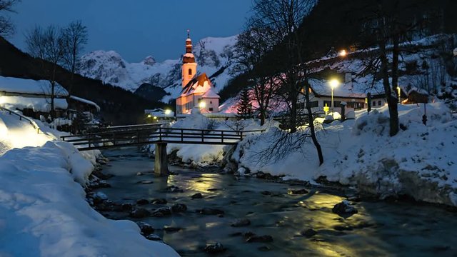Night to day winter time lapse of famous Parish church St. Sebastian, in Ramsau, Berchtesgaden, Bavarian Alps Germany.