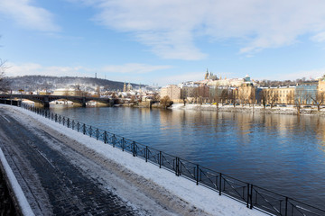 Fototapeta na wymiar Snowy Prague Lesser Town with Prague Castle above River Vltava, Czech republic