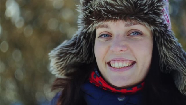4K Close up woman portrait. Beautiful blue-eyed young woman smiles to the camera.