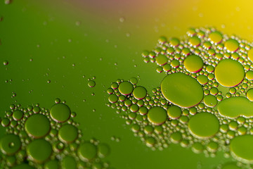 Oil Droplets On Water with Green and Yellow Background