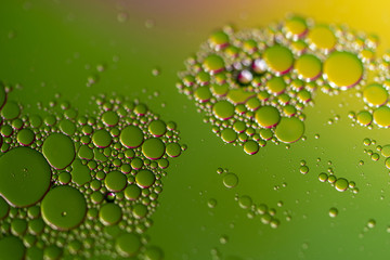 Oil Droplets On Water with Green and Yellow Background