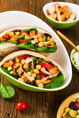 Pita Sandwiches with Grilled Chicken Salad with Chickpea or Garbanzo Beans Salad. Selective focus.