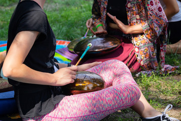 Group of people singing on the drum - hang. Music