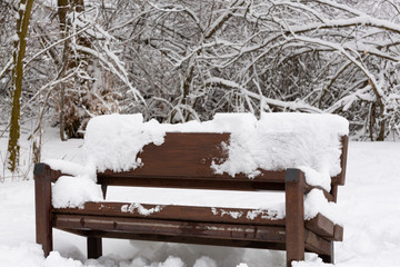 park bench covered in snow - 247670897