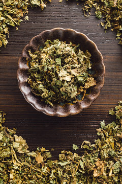 Bowl of Patchouli on Dark Wood