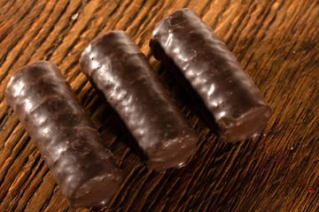Chocolate candies on a wooden background. Close-up