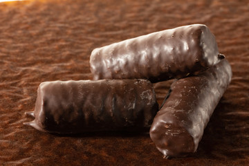 Chocolate bars on brown paper background close-up