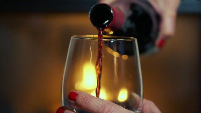 Slow Motion Wine Pour Zoom In to Modern Glass by Fireplace