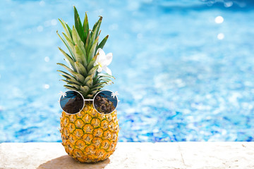 Creative food and travel concept card with hipster ananas in glasses