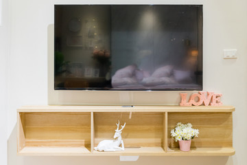 TV cabinet and display with light gray wall, minimalist and vintage interior of living room
