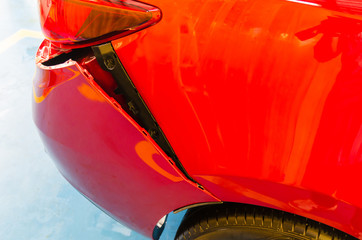 Rear bumper dented red car