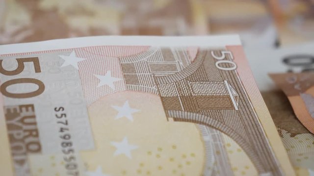 Macro close-up pan over a 50 Euro bank note, currency.