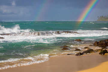 Rainbows on the beach in Hawaii