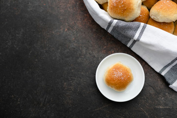 Homemade Dinner Rolls in Bread Basket with One Isolated on Plate
