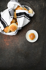 Homemade Dinner Rolls in Bread Basket with One Isolated on Plate