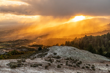 Bright orange sunlight illuminating the freshly fallen snow on the Bay Area Peninsula, Windy Hill Open Space Preserve, California