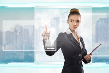 Beautiful business lady works with virtual graphic interface. Futuristic office