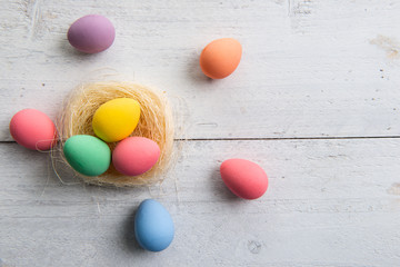 Colored easter eggs on white wooden