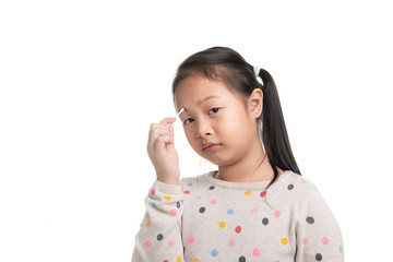 Cute kid southeast asian girl age 7 years in acting with cotton bud isolated on white