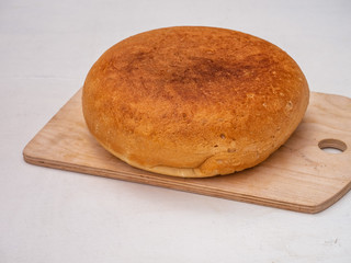 freshly baked homemade bread on a wooden board closeup