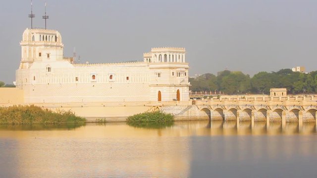 Beautiful Palace structure in middle of the Lakhota lake Jamnagar city stock video I Palace in lake with golden shine