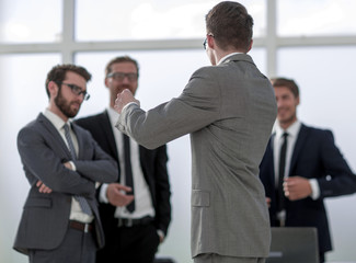 business background.a group of business colleagues standing in the office