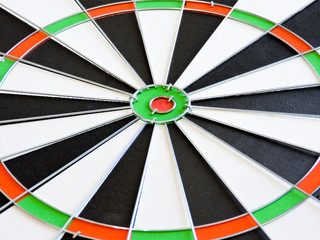 Dart arrow hitting in the target center of dartboard. Success hitting target aim goal achievement...